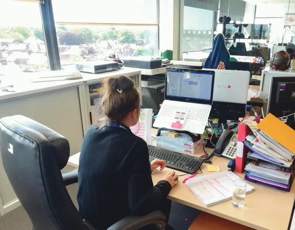 Photograph of Elanor sat at the computer creating the webpage